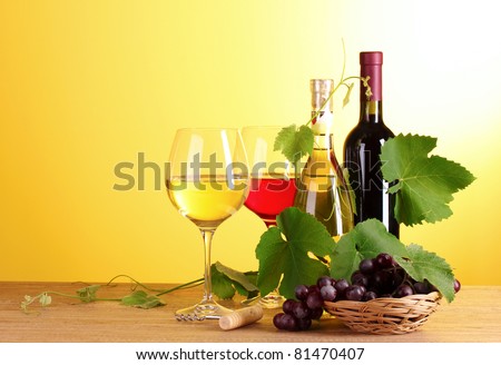 Wine and fruits on yellow background