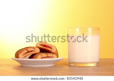 cookies with milk on yellow background