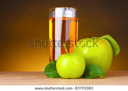 Glass of healthy fresh juice of apples on brown background