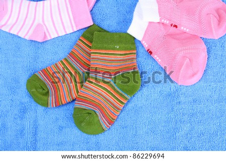 bright baby socks on blue background