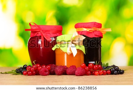 tasty berry and fruit jam and berry on a green background