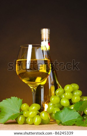 Glass of wine,bottle and grapes on yellow background