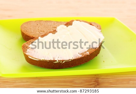 knife and a bread with butter on the plate