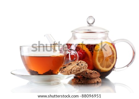 Black fruit tea in glass teaopot and cup isolated on white