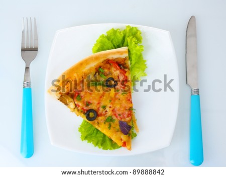 delicious slice of pizza on plate, knife and fork isolated on white