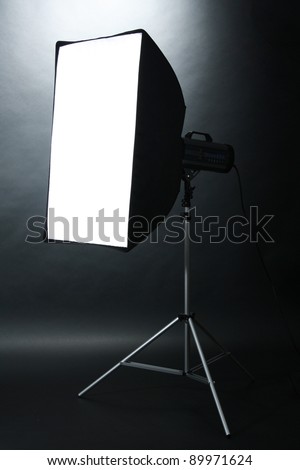 Studio flash with soft-box  on black studio background