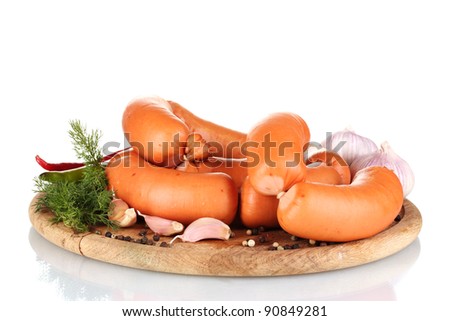tasty sausages on wooden board and spices isolation on white