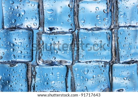 Melting ice cubes on blue closeup
