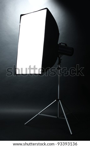 Studio flash with soft-box  on black studio background