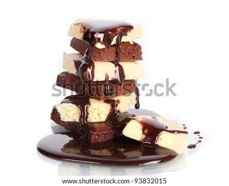 Slices of milk and white chocolate bar poured chocolate isolated on white