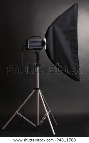 Studio flash with soft-box on black studio background