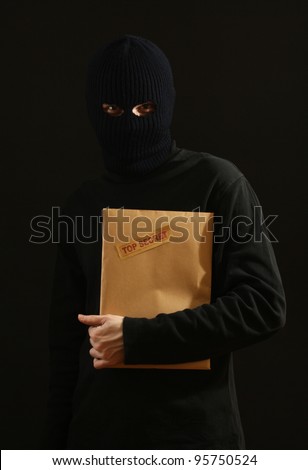 Bandit in black mask with top secret envelope isolated on black