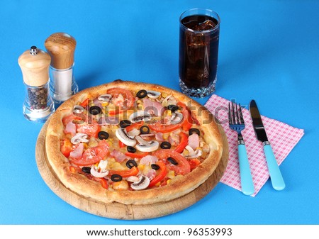 Aromatic pizza with cola on blue background