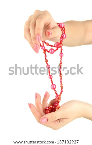 Female hand with pink manicure and bright bracelets, isolated on white