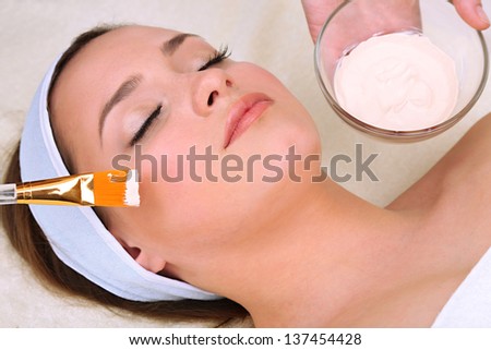 Beautiful young woman in cosmetic salon close up