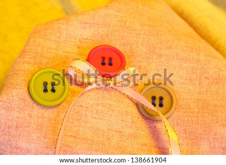 Three buttons on light  cloth