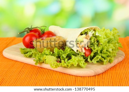Kebab - grilled meat and vegetables, on bamboo mat, on bright background