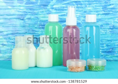 Hotel cosmetics kit on bright color background