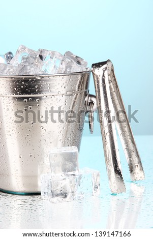 Metal ice bucket on blue background