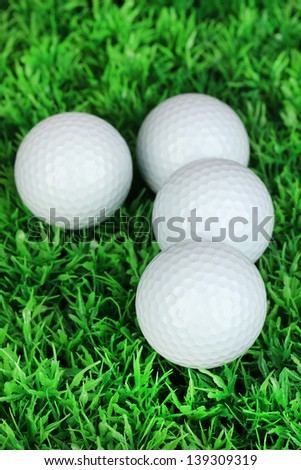 Golf balls on grass close up