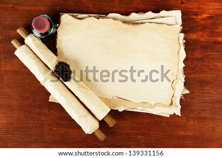 Old paper, ink and scrolls  on wooden background