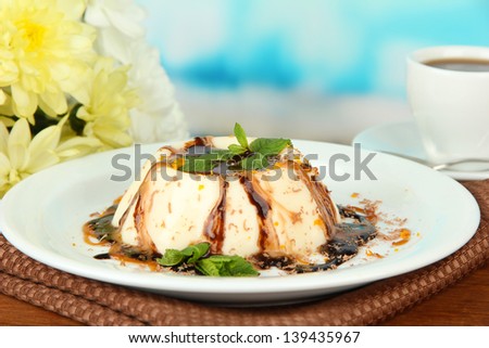 Panna Cotta with chocolate  and caramel sauces, on bright background