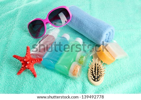 Hotel cosmetics kit on blue towel