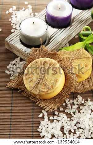 Hand-made soap and sea salt  on grey bamboo mat