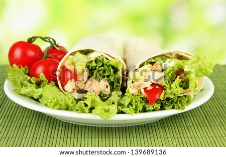 Kebab - grilled meat and vegetables, on bamboo mat, on bright background