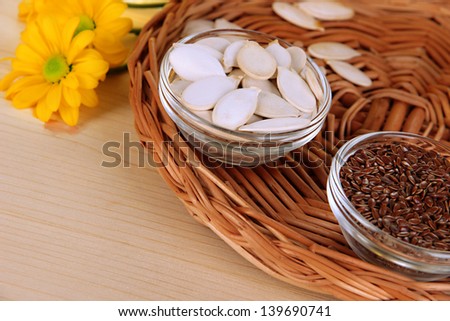 Useful linseed oil and pumpkin seed oil on wooden table close-up
