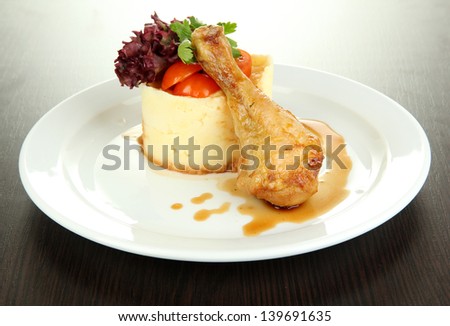 Small portion of food on big plate on wooden table