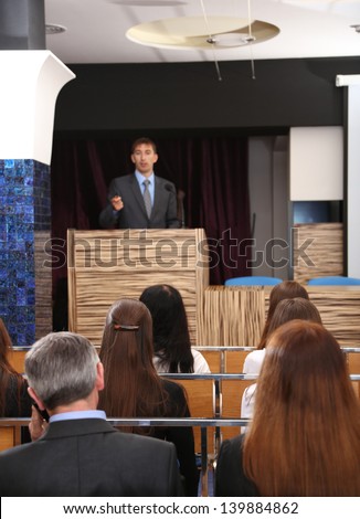 Business man is making a speech at conference room