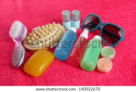 Hotel cosmetics kit on pink towel