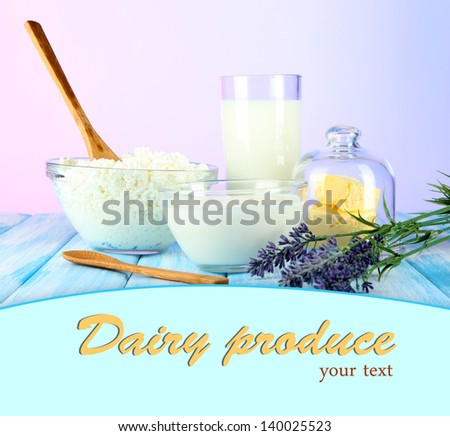 Glass of milk and cheese on table on light background