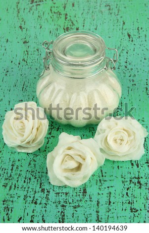 Sugar roses, glass jar with sugar,  on color background