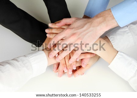 Group of young people\'s hands isolated on white