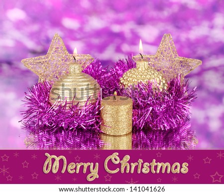 Christmas composition  with candles and decorations in purple and gold colors
