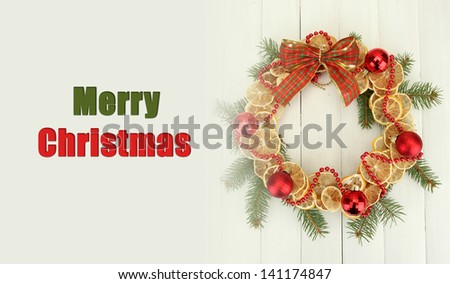 Christmas wreath of dried lemons with fir tree and balls