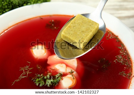 Bowl of soup with bouillon cube, close up