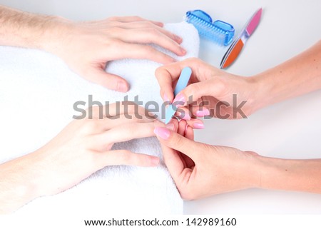 Man doing manicure in salon