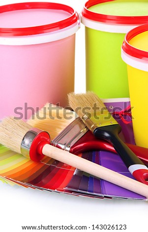 Set for painting: paint pots, brushes, palette of colors close up