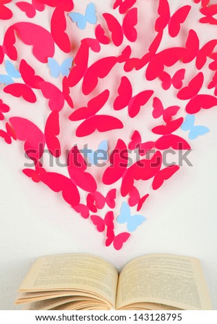 Paper butterflies in form of heart fly out book