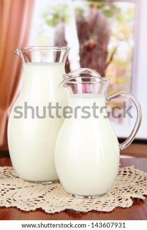 Pitchers of milk on table in room
