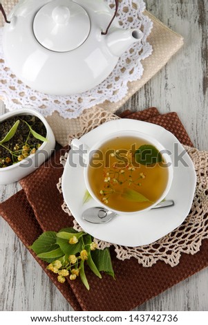 Cup of tea with linden on napkins on    wooden table