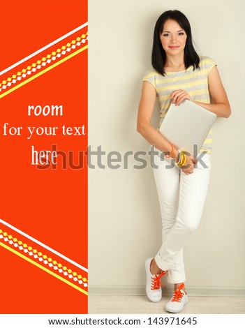 Beautiful young woman with notebook in room