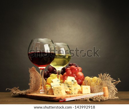 Composition With Wine, Blue Cheese And Grape On Wooden Table, On Grey Background