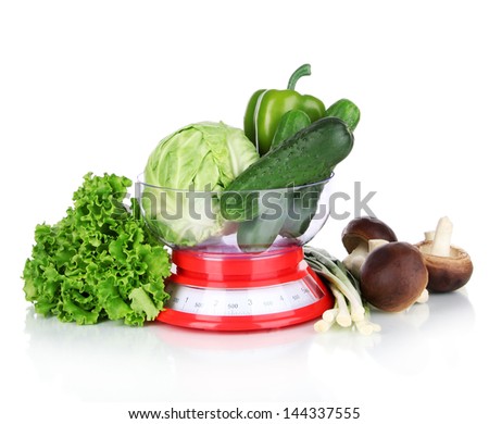Fresh vegetables in scales isolated on white