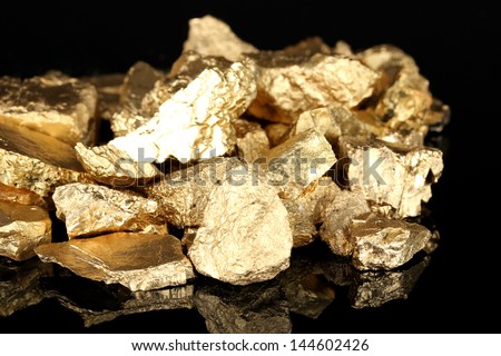 Golden nuggets isolated on black