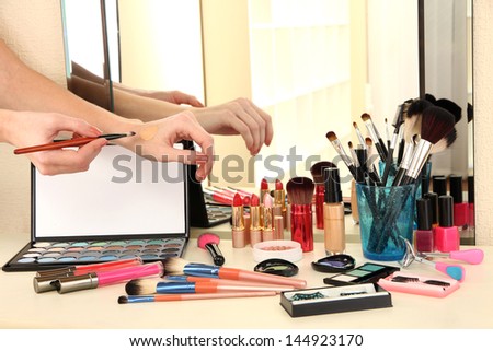 Cosmetics on table near mirrow