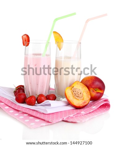 Delicious milk shakes with strawberries and peach isolated on white